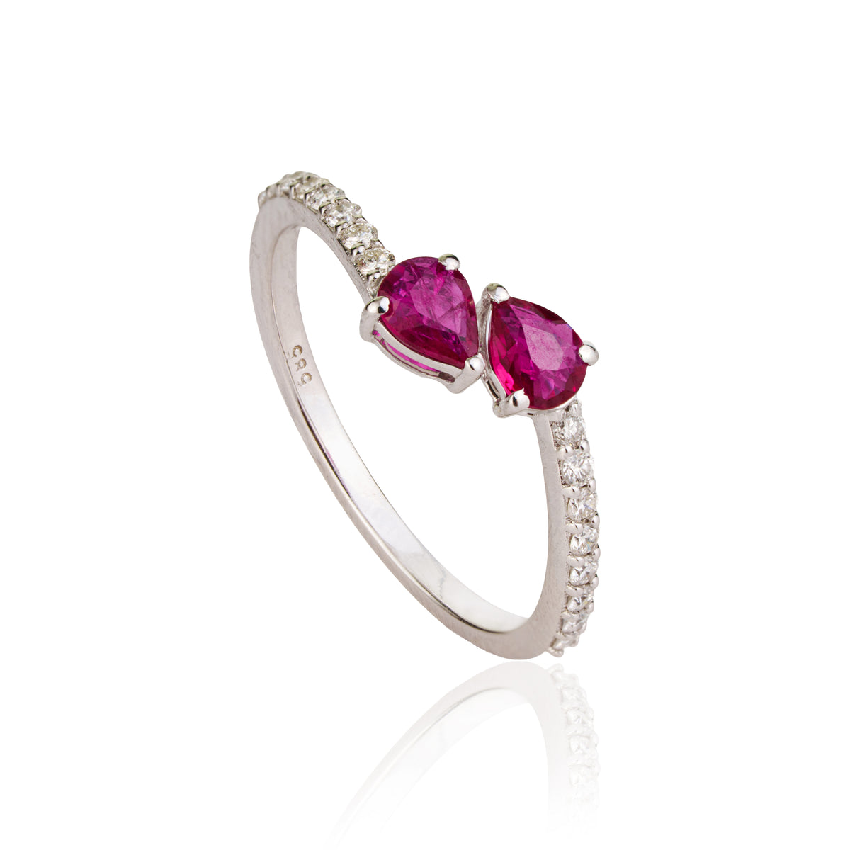 gold open bypass ring featuring two pear-cut natural rubies and diamond accent pavé band on a white background.